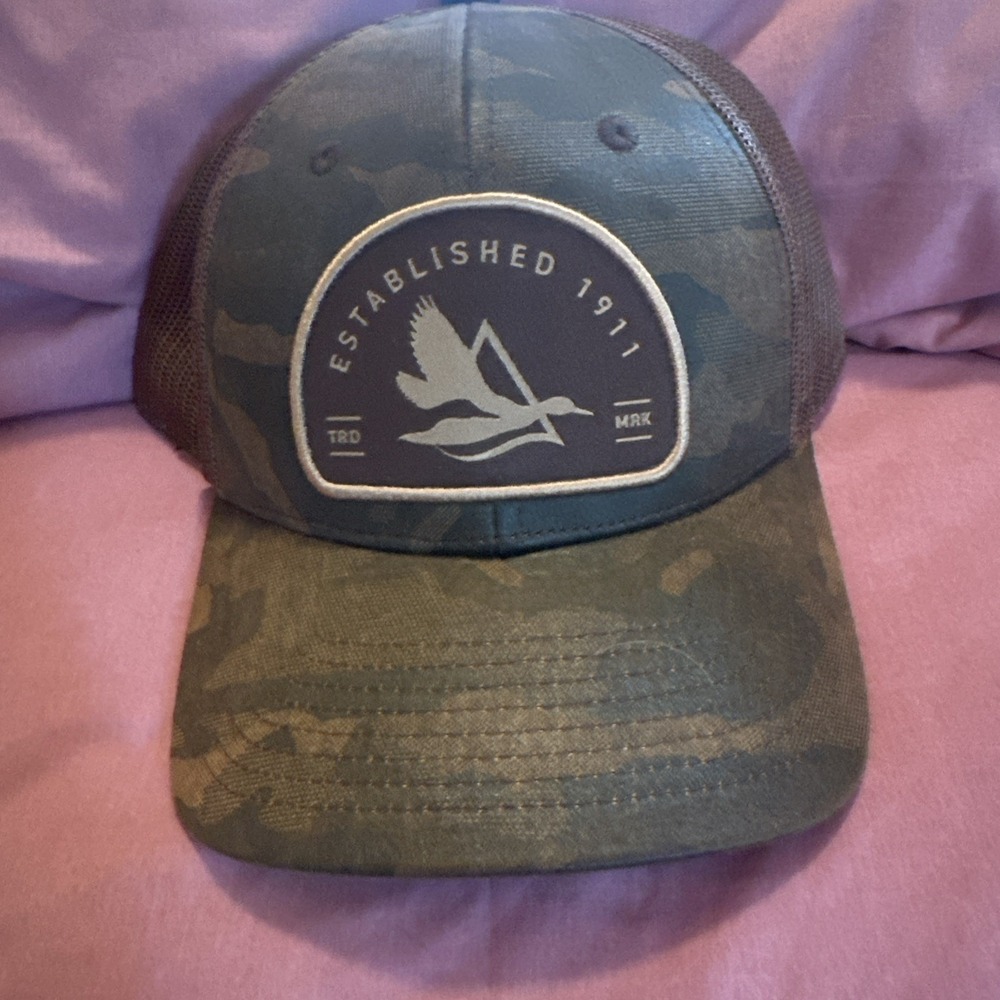 Delta Waterfowl trucker hat features a camo pattern TRD MRK Established 1911